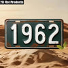 A vintage green aluminum license plate with the year 1962 set against a desert background.