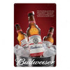 A metal sign featuring a bottle of Budweiser surrounded by ice and condensation.