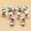 A collection of white ceramic dog pendants in various styles and colors for jewelry making.