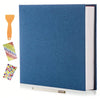 A blue linen scrapbook photo album with a wooden tool and several sheets of self-adhesive photos.