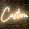 A glowing white neon sign spelling the word Custom is mounted on a textured brick wall.