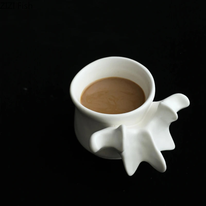 A white ceramic vase shaped like a vertebra holding a brown liquid.