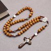 A brown wooden bead rosary necklace with silver accents and a crucifix pendant.