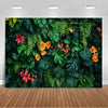 A lush green tropical palm leaf backdrop featuring various large leaves and colorful flowers for party decor.