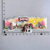 A collection of wooden fridge magnets depicting scenes from Japan, including temples and cherry blossoms.