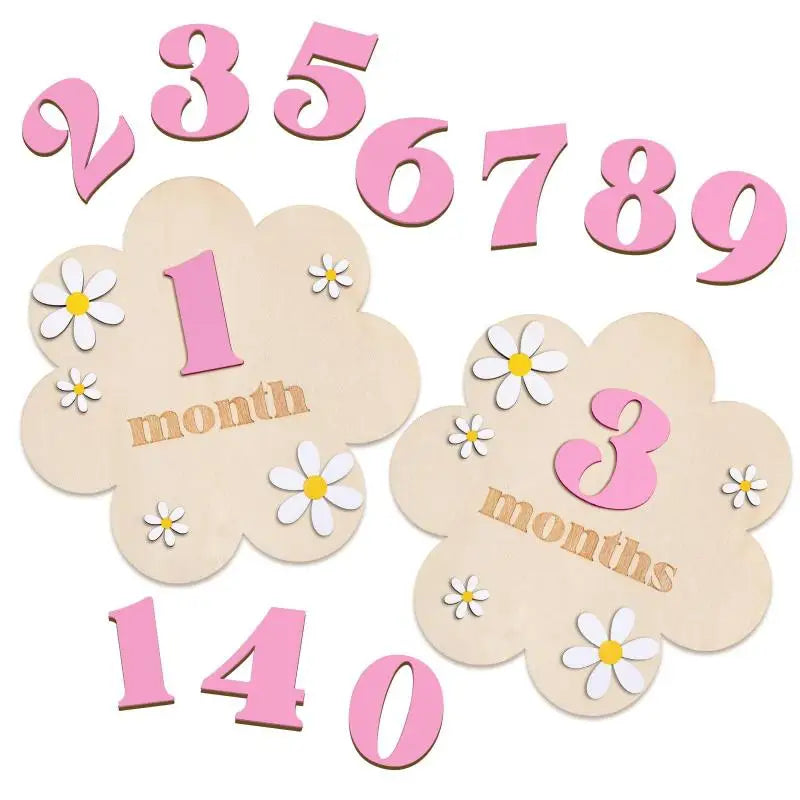 Pink wooden monthly milestone cards showing numbers 1 through 9 and the number 140.