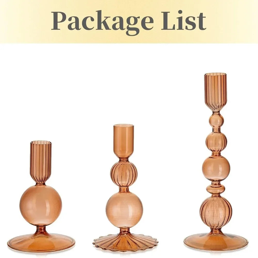A set of three tapered glass candle holders in a warm amber tone.