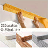 Yellow self-adhesive foam wall trim strips being applied to a white surface.