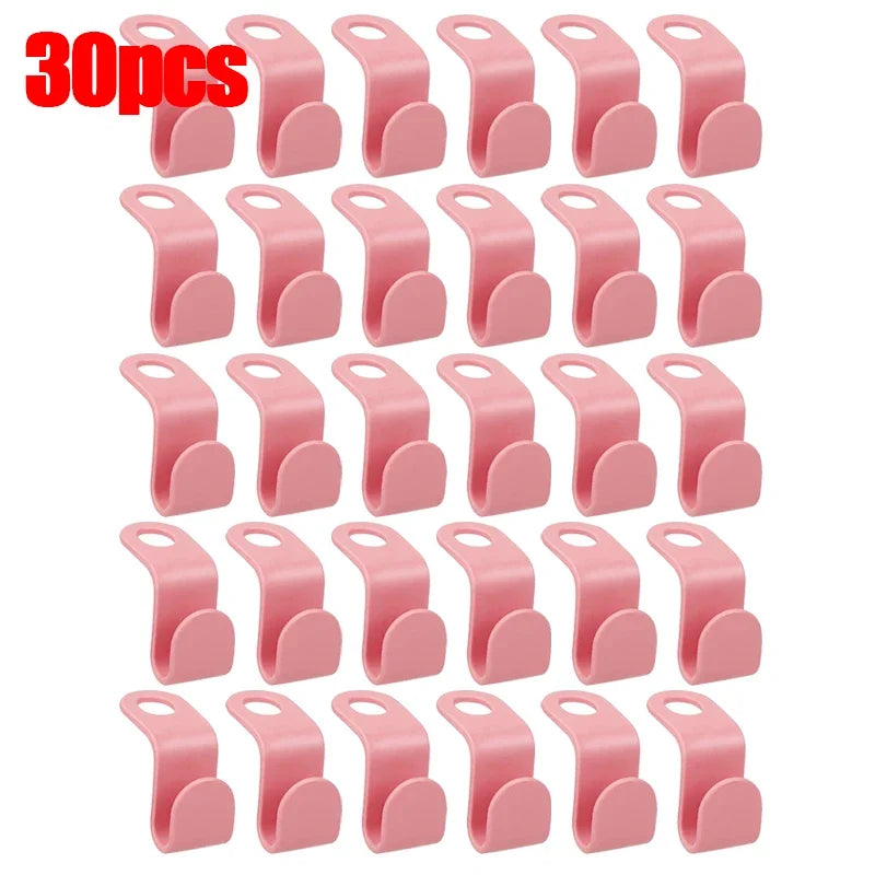 A set of 30 pink space-saving hanger connector hooks for organizing and hanging items.