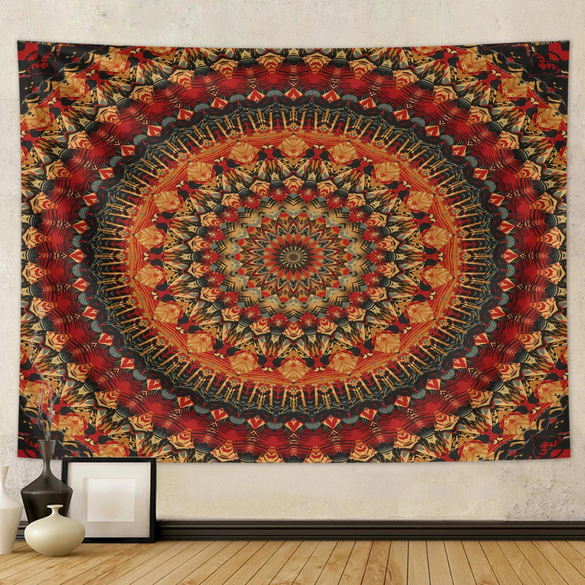 A large bohemian mandala tapestry wall hanging featuring intricate geometric patterns in shades of red, orange, and dark blue