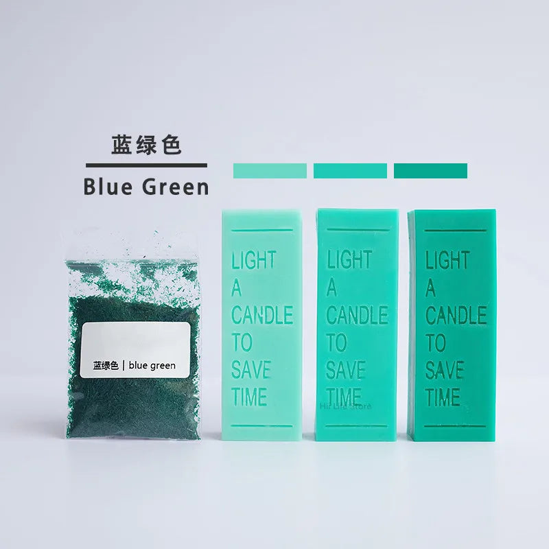 A set of blue green candle dye colorants in various shades, including a jar of blue green powder and three tubes of light blu