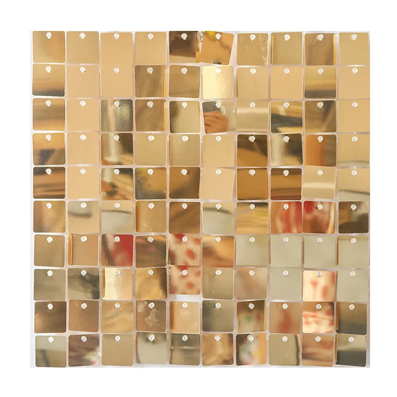 A grid of square iridescent gold and rose gold sequins used as a shimmering wall backdrop.