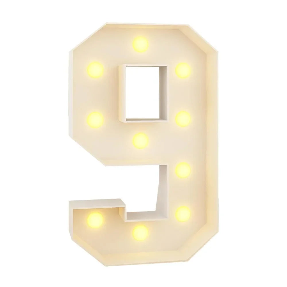 A light-up number nine decoration with illuminated dots on a beige background.