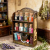 A collection of glass jars filled with glitter powder in various colors displayed on a wooden shelf.