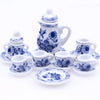 A 15-piece miniature porcelain tea set for a dollhouse featuring a teapot, cups, and saucers in blue and white.