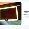 A car sun visor vanity mirror with a warm light LED illumination shown inside a vehicle.