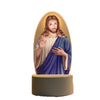 A ceramic figurine of Jesus Christ with long hair and beard, depicted in a serene pose.