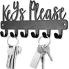 A black wall-mounted metal key holder with hooks and several keys attached.