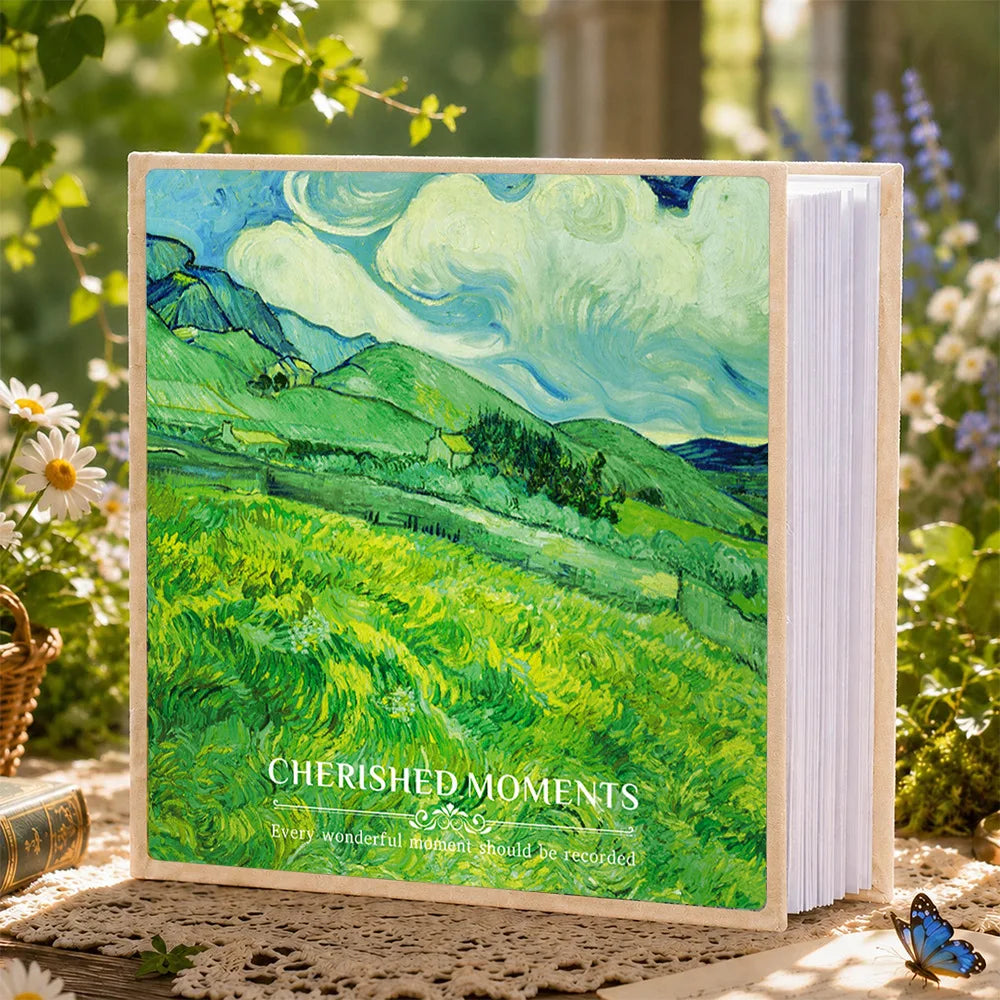 A green landscape painting on a laminated photo album with the text Cherished Moments
