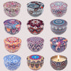 A collection of nine decorative aromatherapy soy wax candles in various intricate patterns and colors.