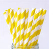 A bundle of yellow and white striped paper drinking straws is displayed in a glass container.