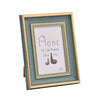 A rectangular wooden photo frame with a distressed teal border displaying the text Home is Where The Is and two small wooden 