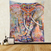 Bohemian mandala tapestry wall art featuring a colorful elephant face with intricate patterns and dangling elements.