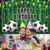 A vibrant green soccer field backdrop decorated with balloons, confetti, and a happy birthday banner.
