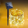 A bundle of warm yellow string lights is shown next to a solar panel and mounting pole.