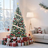 A flocked artificial Christmas tree decorated with red and green ornaments and warm white lights in a bright room.