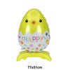 A yellow foil balloon shaped like a chick with a happy face and a white bunny theme.