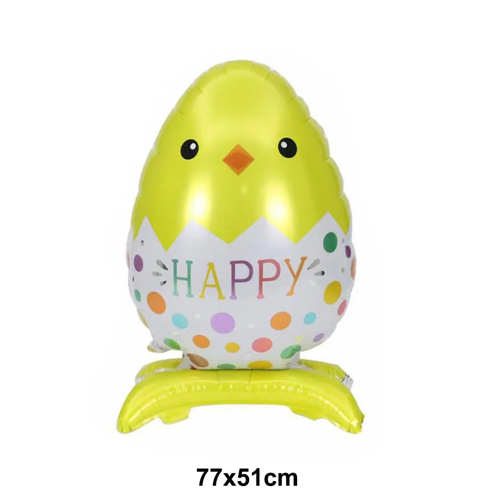 A yellow foil balloon shaped like a chick with a happy face and a white bunny theme.