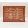 A wooden money saving box with a grid tracker for goals, featuring various numbered slots.