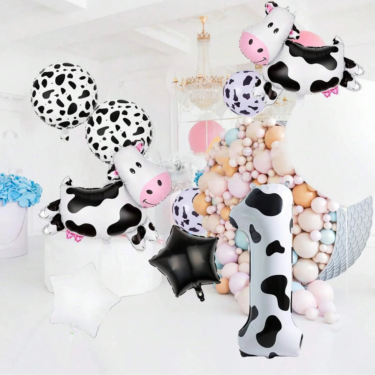 A set of cow print number balloons featuring black and white spots in various sizes and shapes.