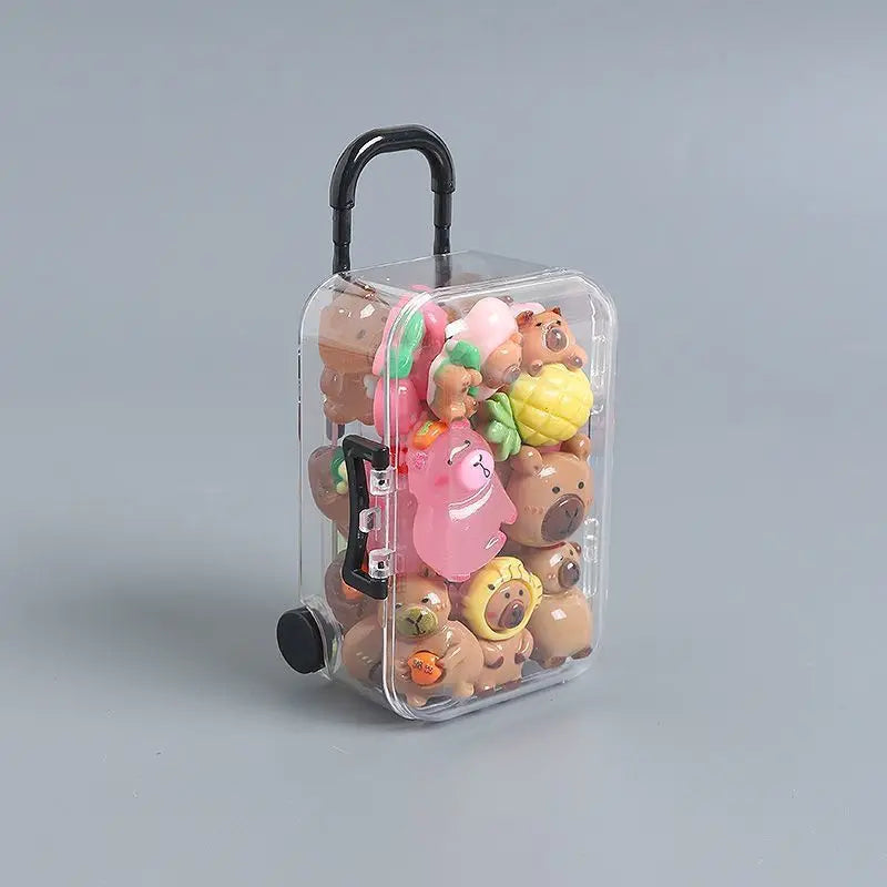 A clear plastic suitcase figure filled with small, soft-glow capybara mini figures.
