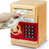 A hand is inserting a banknote into a gold and red combination lock piggy bank.