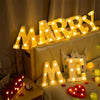 Luminous LED alphabet night light spelling out MARRY ME on a sofa for party decor