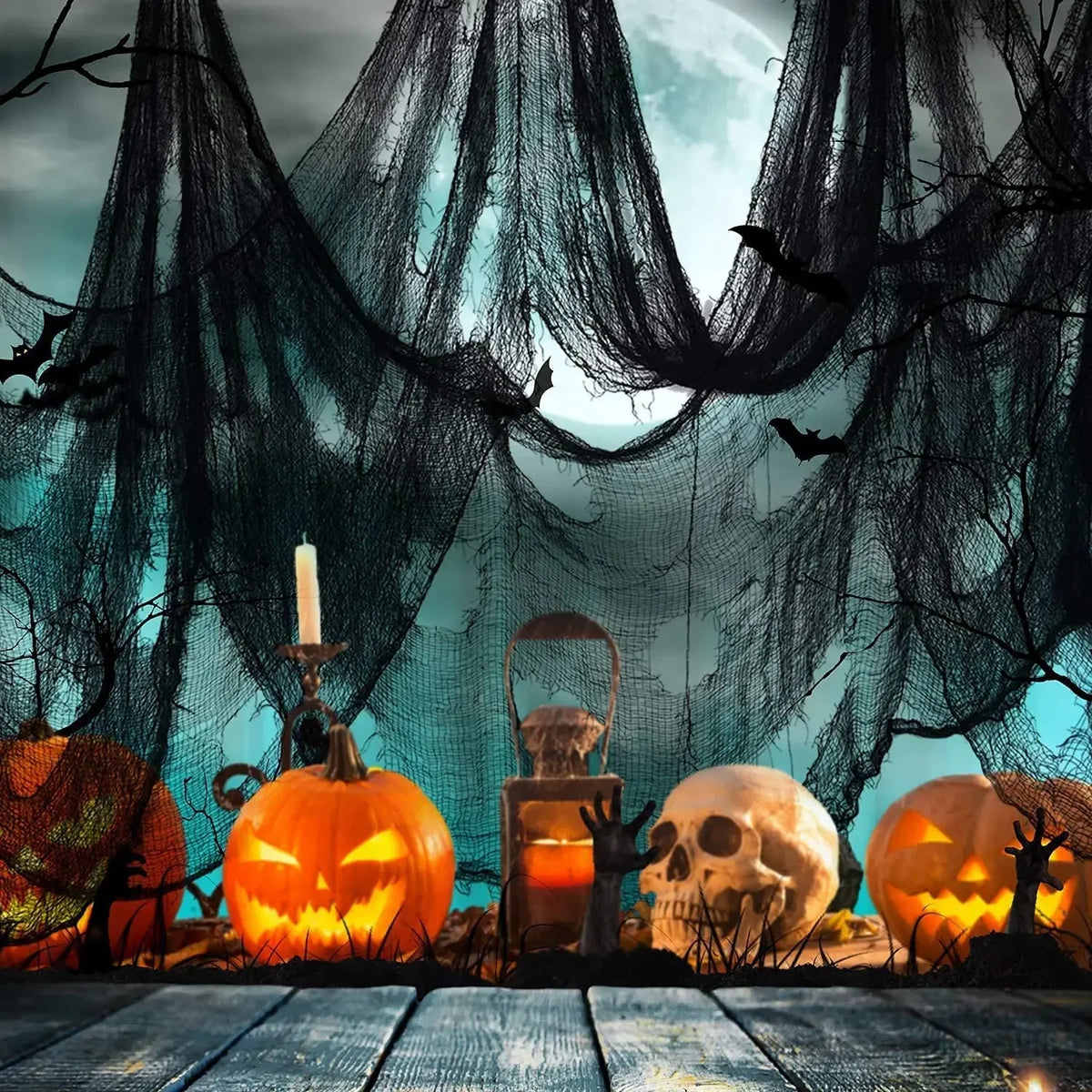 A spooky Halloween display featuring carved pumpkins, a skull, and dark gauze fabric against a blue sky background.