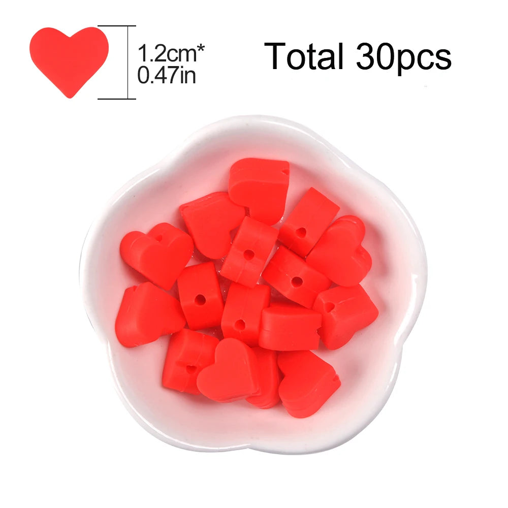 A pile of red silicone heart beads in a white dish, with a heart shape indicating the bead size.