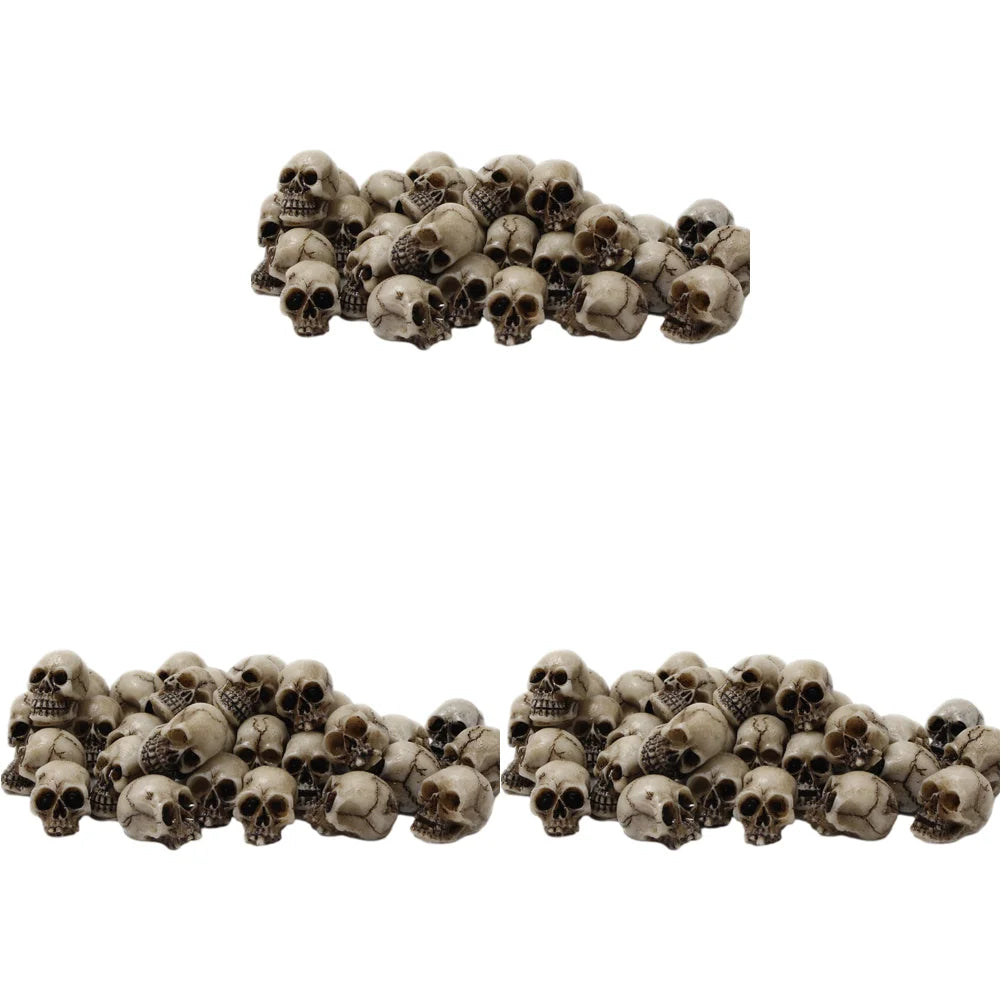 A set of realistic skull figurines used for Halloween and gothic decor.