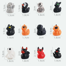 A collection of twelve mini Halloween figurines in various colors and styles, including black, orange, white, and gray.