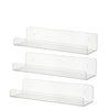 Three clear acrylic floating display shelves mounted on a wall.