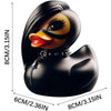 Black rubber duck figurine with yellow accents and a black collar, shown from the side.