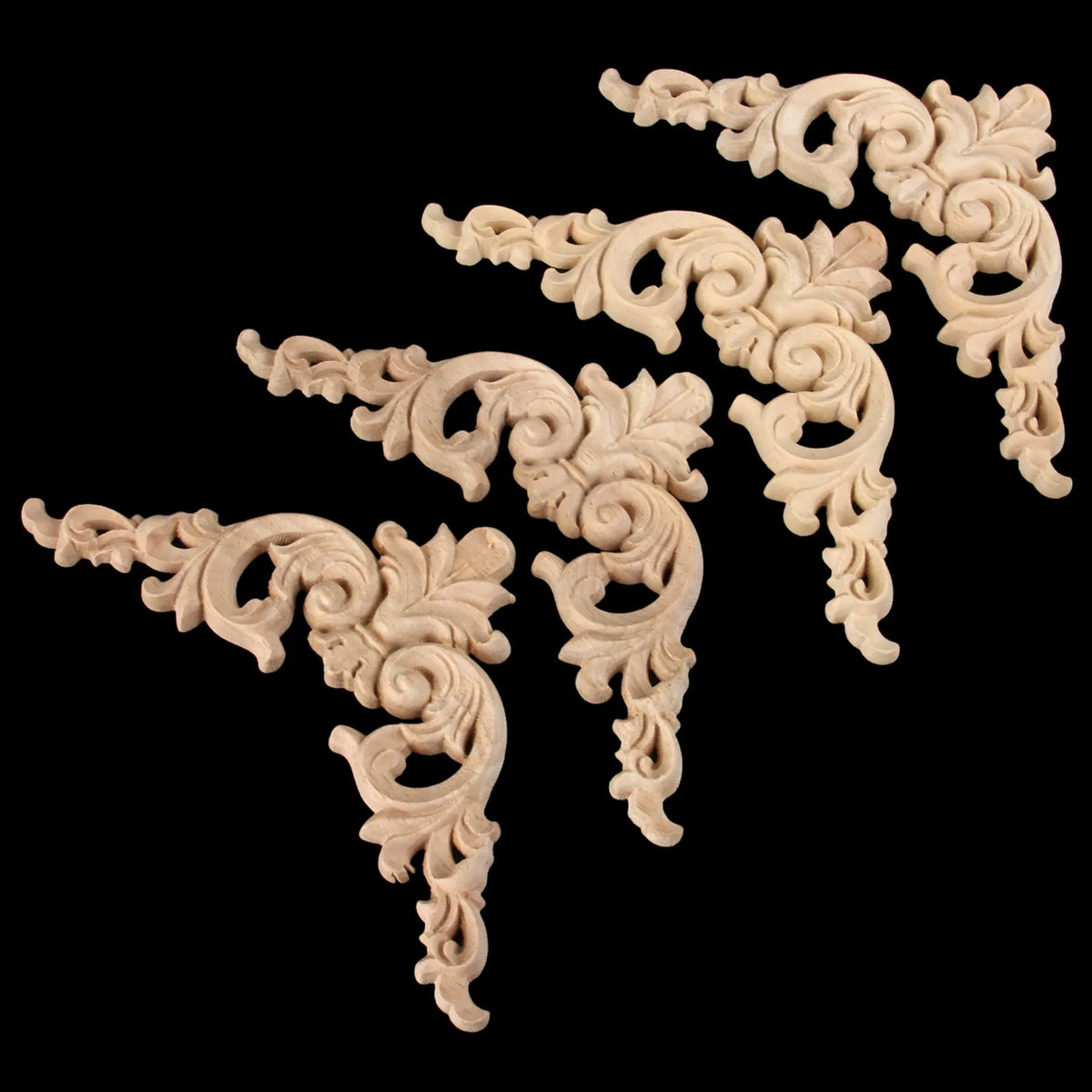 A set of two light-colored oak wood corner carvings featuring intricate European branch and crown designs.
