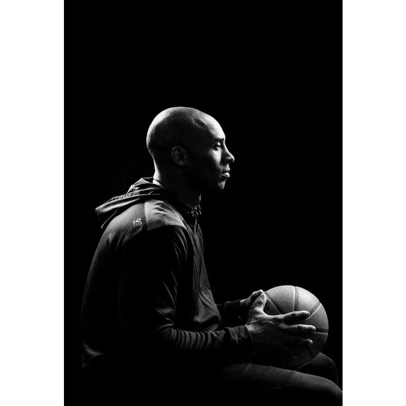 A man in a dark shirt is shown in profile against a black background, likely for basketball art.