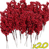 A dense cluster of artificial red holly berry stems used for Christmas decoration.