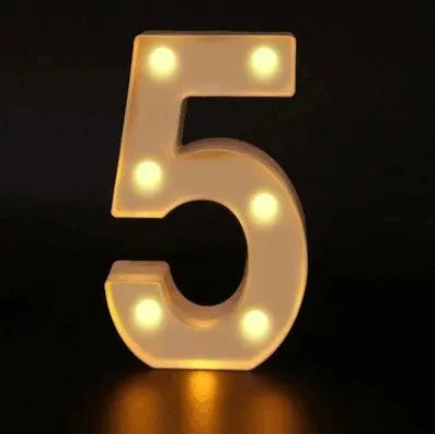 A luminous LED alphabet night light shaped like the number five, glowing yellow on a dark surface.