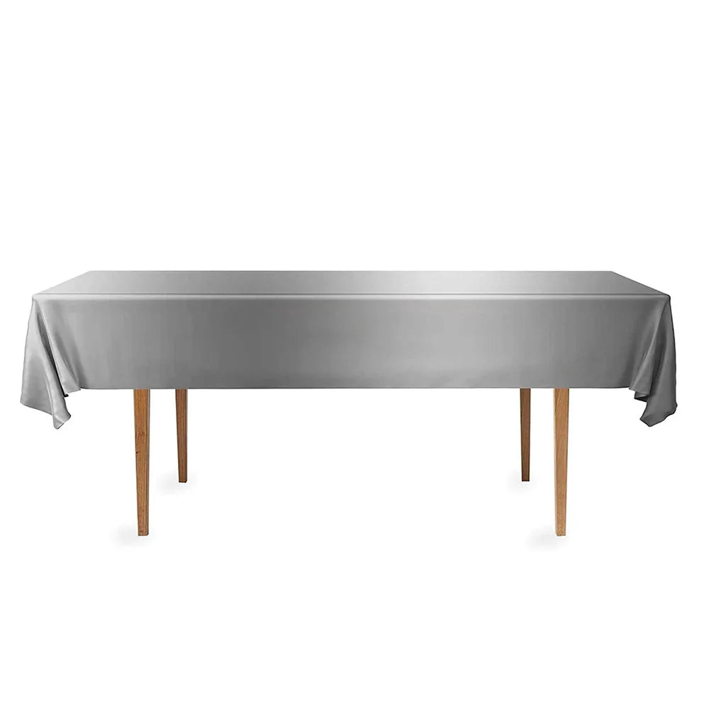 A rectangular gray disposable tablecloth displayed on a wooden table.