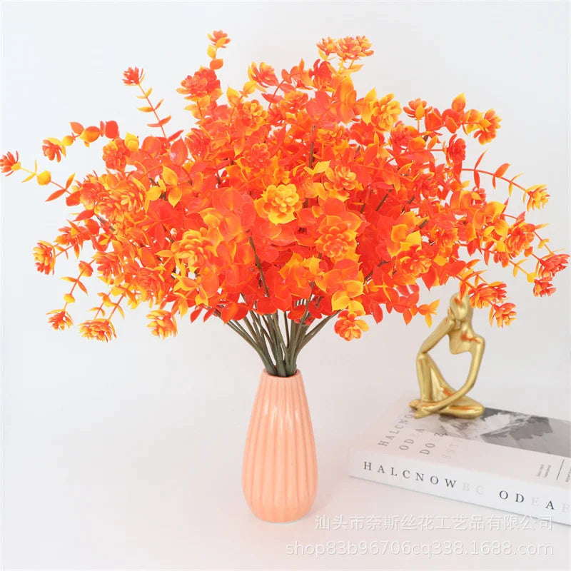 A vibrant bouquet of orange and yellow artificial daisies used for autumn home decor.