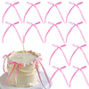 A set of pink bowknot ribbon cake toppers for birthday and wedding cakes, featuring various styles.
